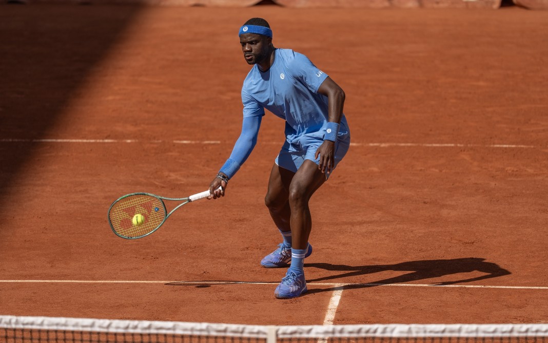 Frances Tiafoe hits a shot against Roman Safiullin at the 2025 French Open in Roland Garros.